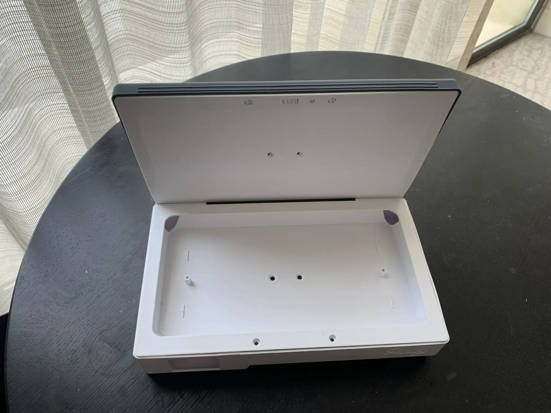 Early 3D printed Purivy enclosure prototype shown open, with screw bosses, standoffs and lamp mounting holes visible in the tray