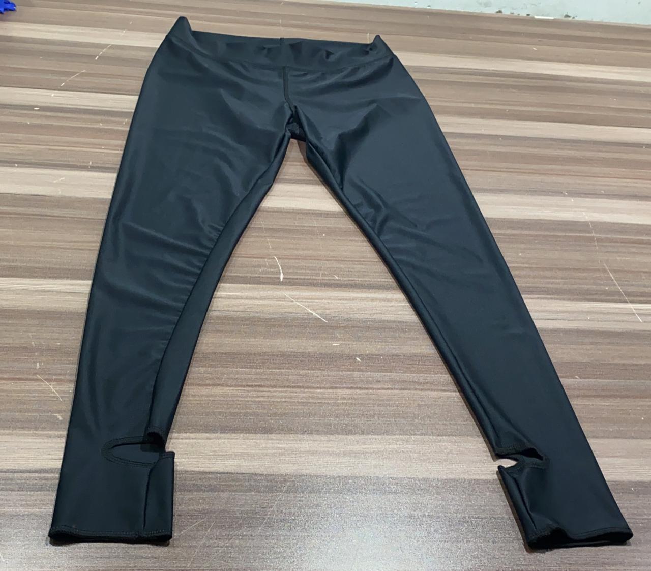 Plain black Kool Pressions compression legging proof-of-concept prototype laid flat on a workbench