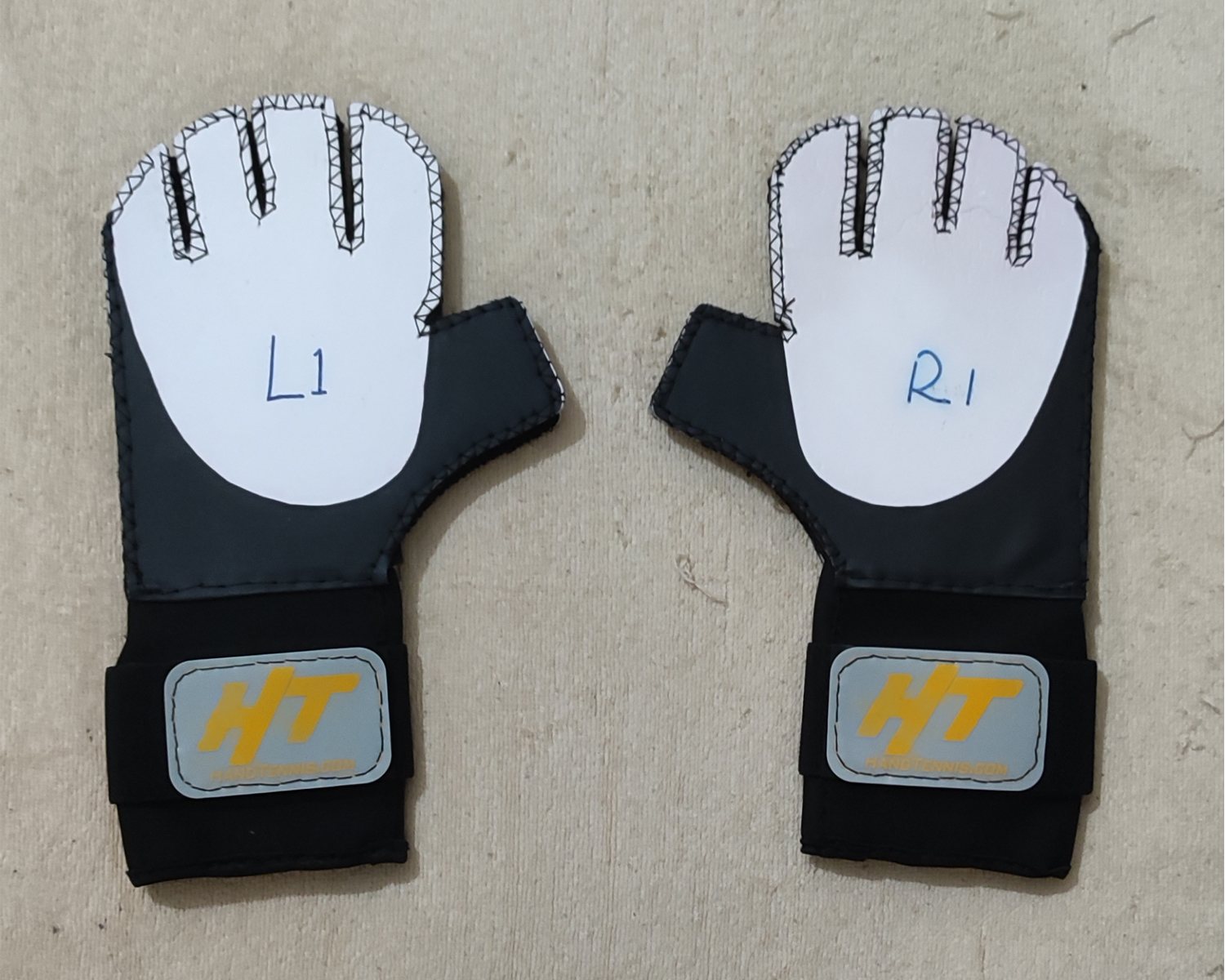 Left and right first-article Hand Tennis prototype gloves marked L1 and R1