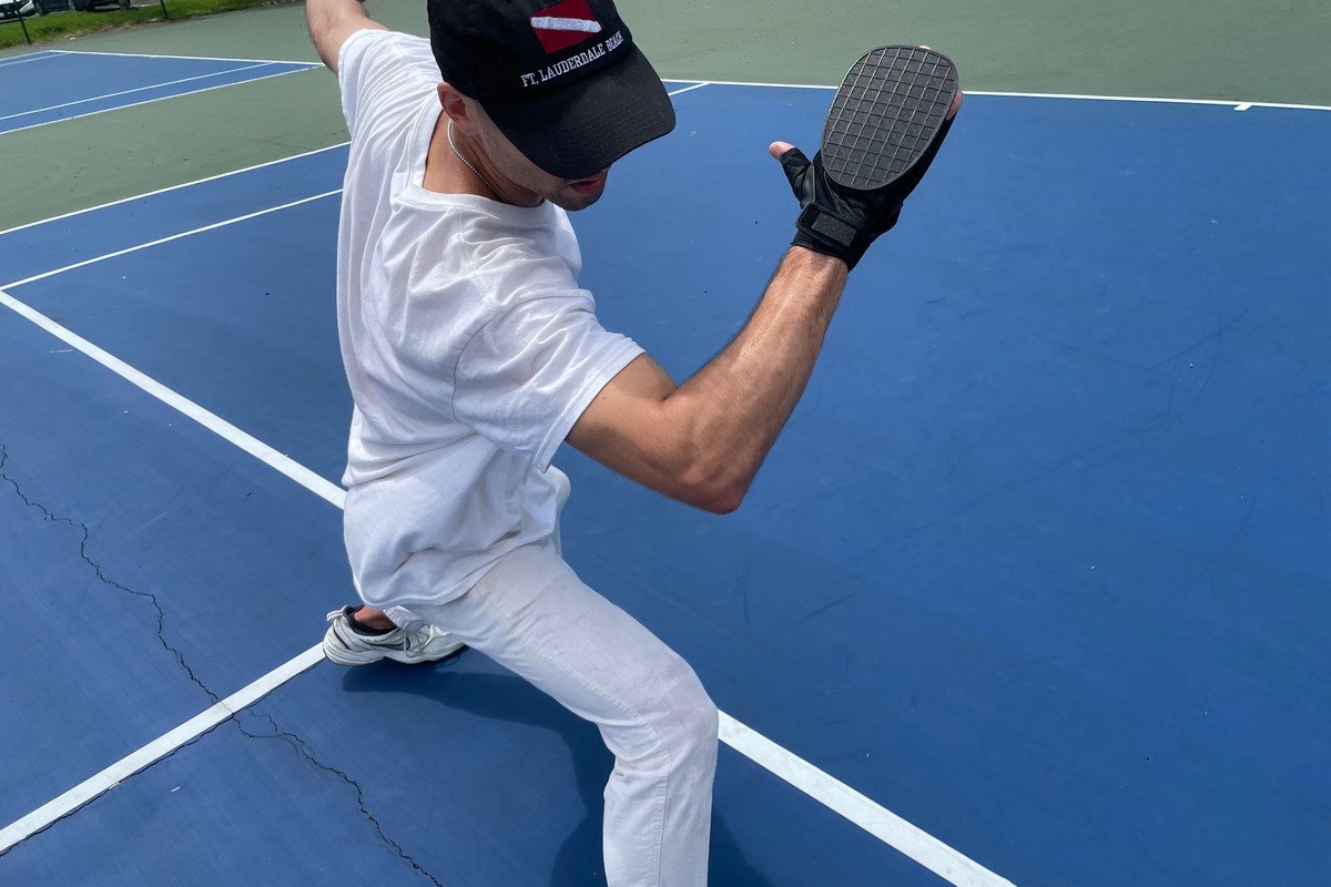 Hand Tennis glove in play on a tennis court