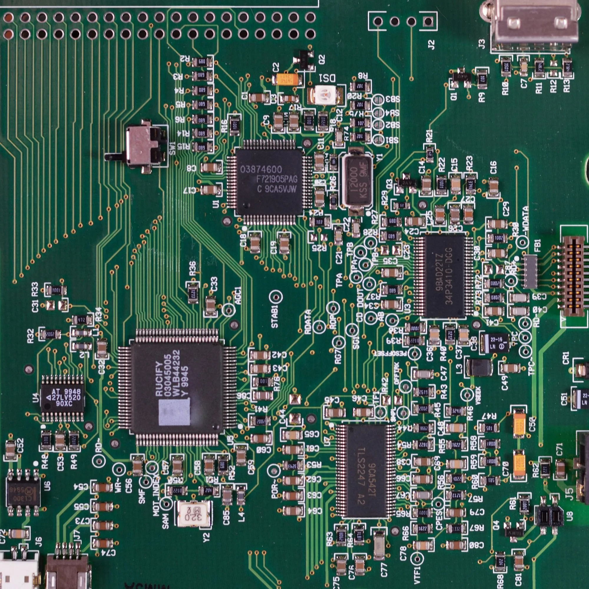Electronic product design company workbench: PCB layout on EDA monitor with assembled prototype board